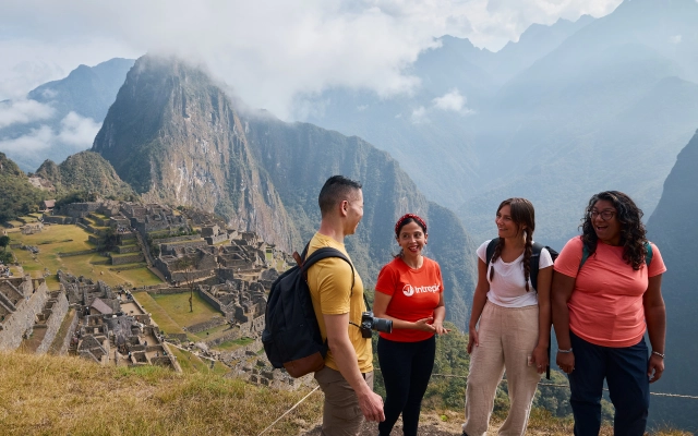 Four travelers in front of Machu Picchu